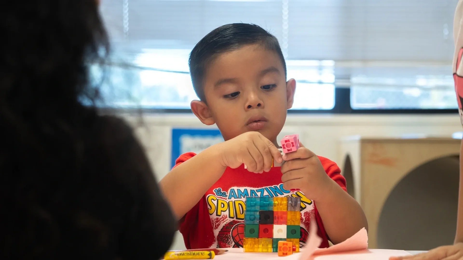 a little boy playing with blocks